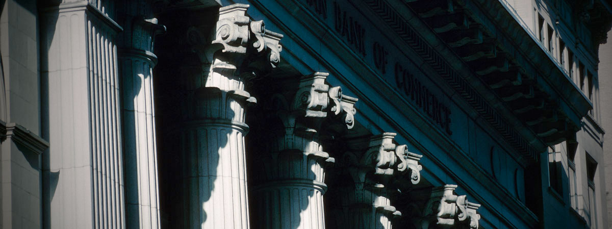 A row of columns in sunlight with strong shadows